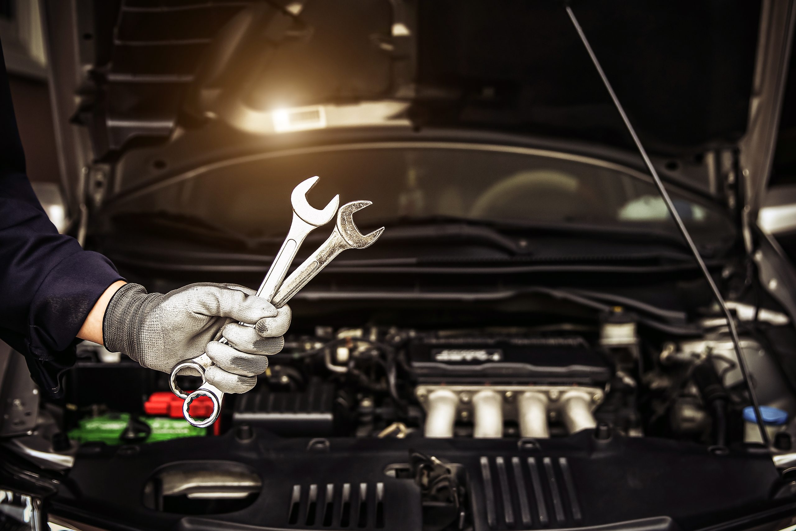 Mechanic holding the wrench to repairing car engine problem.